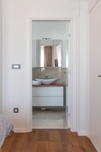 a bathroom with a sink and a mirror at Villa DEA - Dein Rückzugsort am Meer mit beheiztem Pool in Vrsi