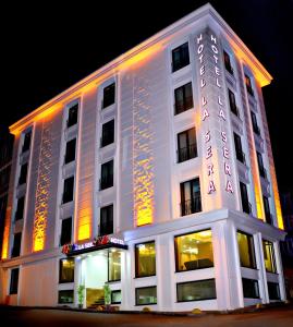 a white building with a lit up sign on it at Hotel La SERA in Istanbul