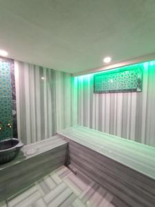 a bathroom with a bath tub with a window at Grand Park Hotel Spa Beylıkduzu Istanbul in Esenyurt