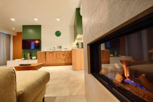 a living room with a fire place in the wall at Sun&Sport Apartament FOREST prywatna sauna w cenie in Szczyrk