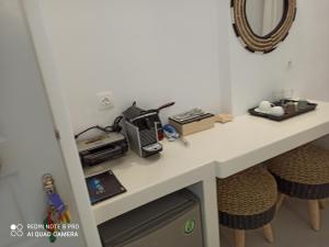 a desk with a computer and a printer on it at Kleri's apartments 2 in Tinos Town