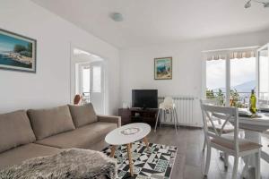 a living room with a couch and a table at Villa Olivia in Veprinac