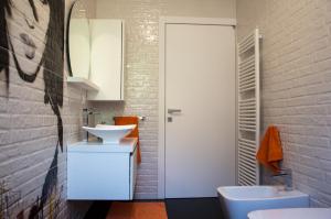 a bathroom with two sinks and a white door at Il nido di Marty in Issogne