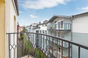 an apartment balcony with a view of buildings at Grand Apartments - Boho Sopot Apartament dwupoziomowy in Sopot