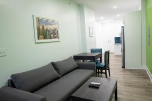 a living room with a couch and a table at Peachtree Suites - Jersey City in Jersey City