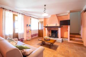 a living room with a couch and a fireplace at Agriturismo Le Vigne in Foligno