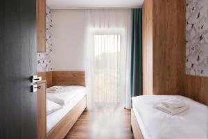 Ένα ή περισσότερα κρεβάτια σε δωμάτιο στο Apartmány Pálenica & Ostredok - Galeria Apartments Jasná Lúčky