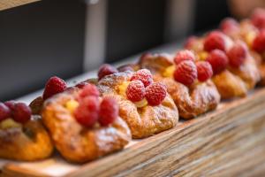 a bunch of pastries with raspberries on top of them at Shangri-La Shougang Park, Beijing in Beijing