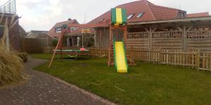 a playground in the yard of a house at FeWo Baltrum in Roggenstede in Dornum