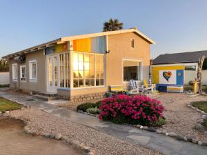 a small house with a rainbow at Quaint Seaside Cottage in Swakopmund