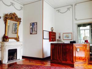 a living room with a fireplace and a mirror at Hotel Milano in Sanremo