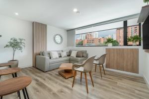 a living room with a couch and a table at Apartamentos Go Living & Suites by HOUSY HOST in Medellín