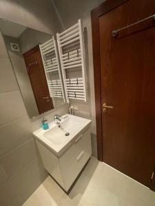 a bathroom with a sink and a mirror at Lovely 2-bedroom serviced apartment with SPA in Bansko +16 photos