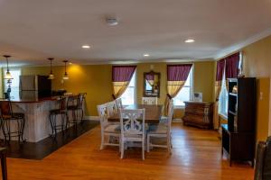 a kitchen and dining room with a table and chairs at Beach Walk Hotel in Ocean City