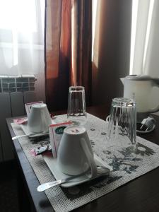 a table with plates and glasses on a table at Villa Dobry Adres in Dziemiany