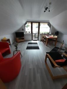 a living room with a couch and a table at FeWo Karola in Ellenz-Poltersdorf