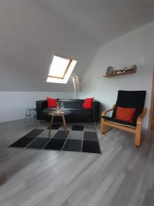 a living room with a couch and a table at FeWo Karola in Ellenz-Poltersdorf