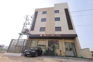 a car parked in front of a building at The Grand Tree Hotel in Agra