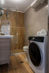a bathroom with a toilet and a washing machine at Vista Magica in Chania Town