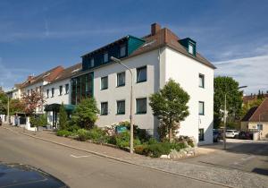 a white building on the side of a street at Hotel Klughardt in Nuremberg