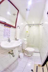 a bathroom with a sink and a toilet at Hotel Colonial Internacional in Bogotá