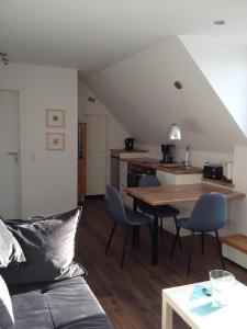ein Wohnzimmer mit einem Tisch und Stühlen sowie eine Küche in der Unterkunft Feriendomizil Ösetalblick in Bad Driburg
