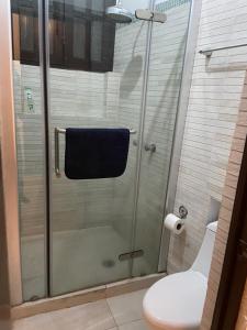 a bathroom with a shower with a toilet and a towel at Casa colonial en el corazón del Centro Histórico in Mexico City