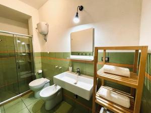 a bathroom with a sink and a toilet and a mirror at Casa Serra in Porto Palo