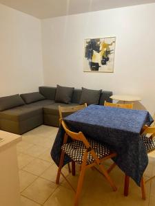 a living room with a couch and a table and chairs at Villa Amari in Brela