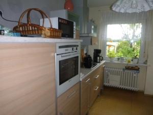 a kitchen with a white stove top oven next to a window at Maja in Guhrow