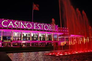 a casino resort lit up in purple at night at Villa Sublime in Colares