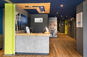 a lobby with a reception counter in a building at ibis budget Saint Malo Centre in Saint Malo