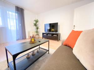 a living room with a couch and a tv at Apartment Mozart in Gernsbach
