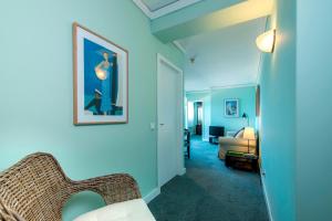 a room with a chair and a bed in a room at Hotel Apartamento Solverde in Espinho
