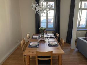 a dining room table with chairs and a chandelier at Schlossblick - a62076 in Heidelberg