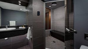 a bathroom with a sink and a glass shower at Midlands Park Hotel in Portlaoise