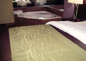 a hotel room with a bed and a bath tub at Comfort Inn & Suites Dothan East in Dothan