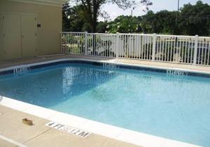 a large swimming pool with a white fence at Comfort Inn & Suites Dothan East in Dothan