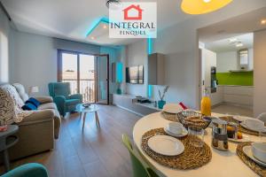 a kitchen and living room with a table and chairs at Palamós Luxe Apartments in Palamós