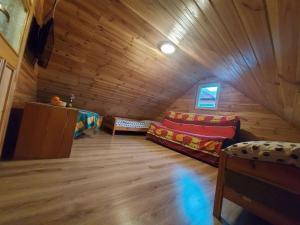 a room with two couches in a log cabin at Apartament Ruska Bania Na Pograniczu in Lasowka +12 photos