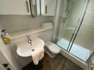 a bathroom with a sink and a shower and a toilet at Britannia Apartments in Edinburgh