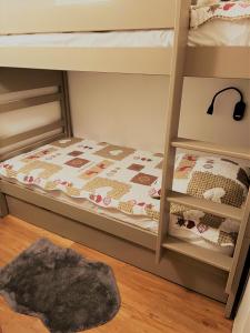 a childs bedroom with bunk beds with a rug at Les Pierres Blanches Mont Blanc in Les Contamines-Montjoie