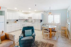 a kitchen with a couch and a chair and a table at Sand Dollar I 301 in Ocean City