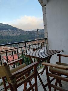 a table and chairs on a balcony with a view at Kristi's Homes - "Beautiful Dome" in Dimitsana in Dhimitsana