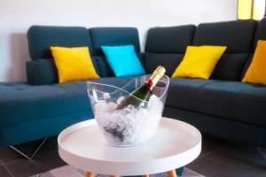 a bottle of wine on a table in front of a couch at Caribbean’ZEN in Petit-Bourg