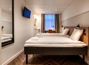 Postel nebo postele na pokoji v ubytování Go Hotel Saga