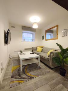 a living room with a couch and a table at Cosy Riverside Apartment - FREE PARKING in York