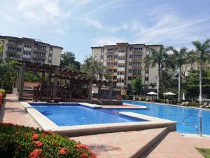 a swimming pool at a resort with buildings at Oceanview 6th Floor Jaco Condo in Jacó