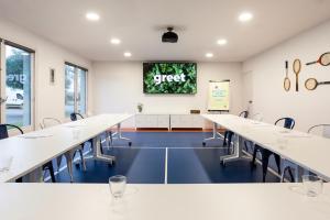a conference room with white tables and chairs at greet hôtel Angoulême in Saint-Yrieix-sur-Charente