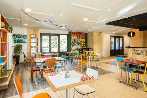 a restaurant with tables and chairs in a room at greet hôtel Angoulême in Saint-Yrieix-sur-Charente